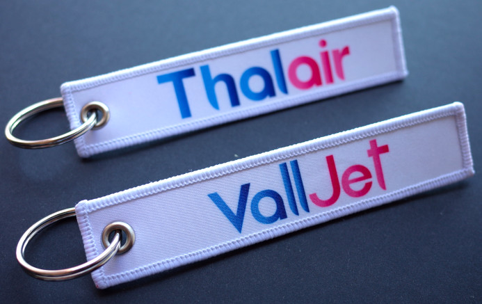 printed keychains with a white background and a gradient colored logo